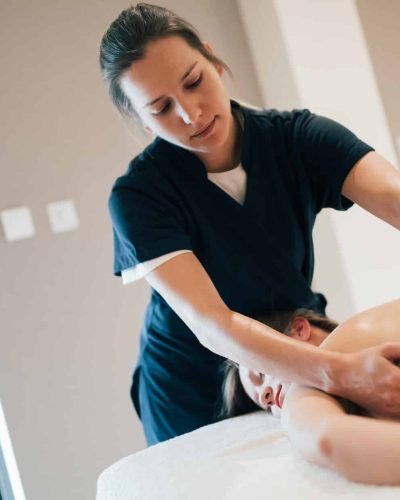 Stress relieving massage by young smart therapist